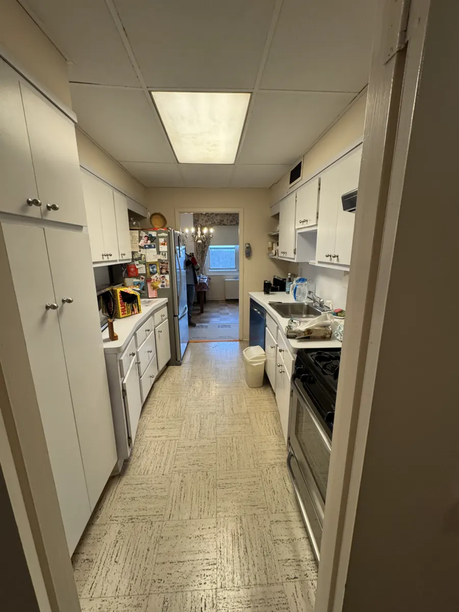 Original Glen Ridge galley kitchen with cabinets and appliances lining both sides of the narrow room