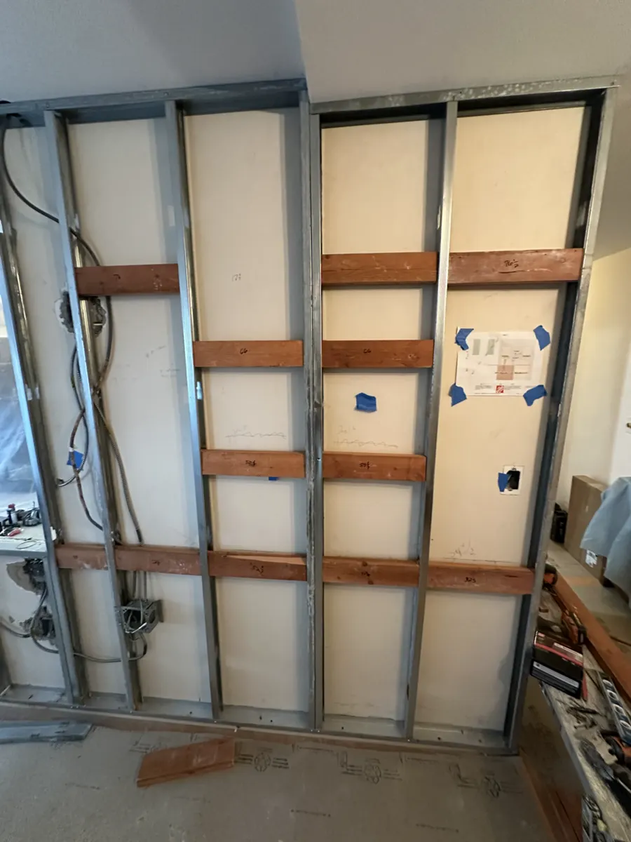 New framing added to the original 2¼-inch-thick wall before cabinets were installed on this side of the Glen Ridge kitchen