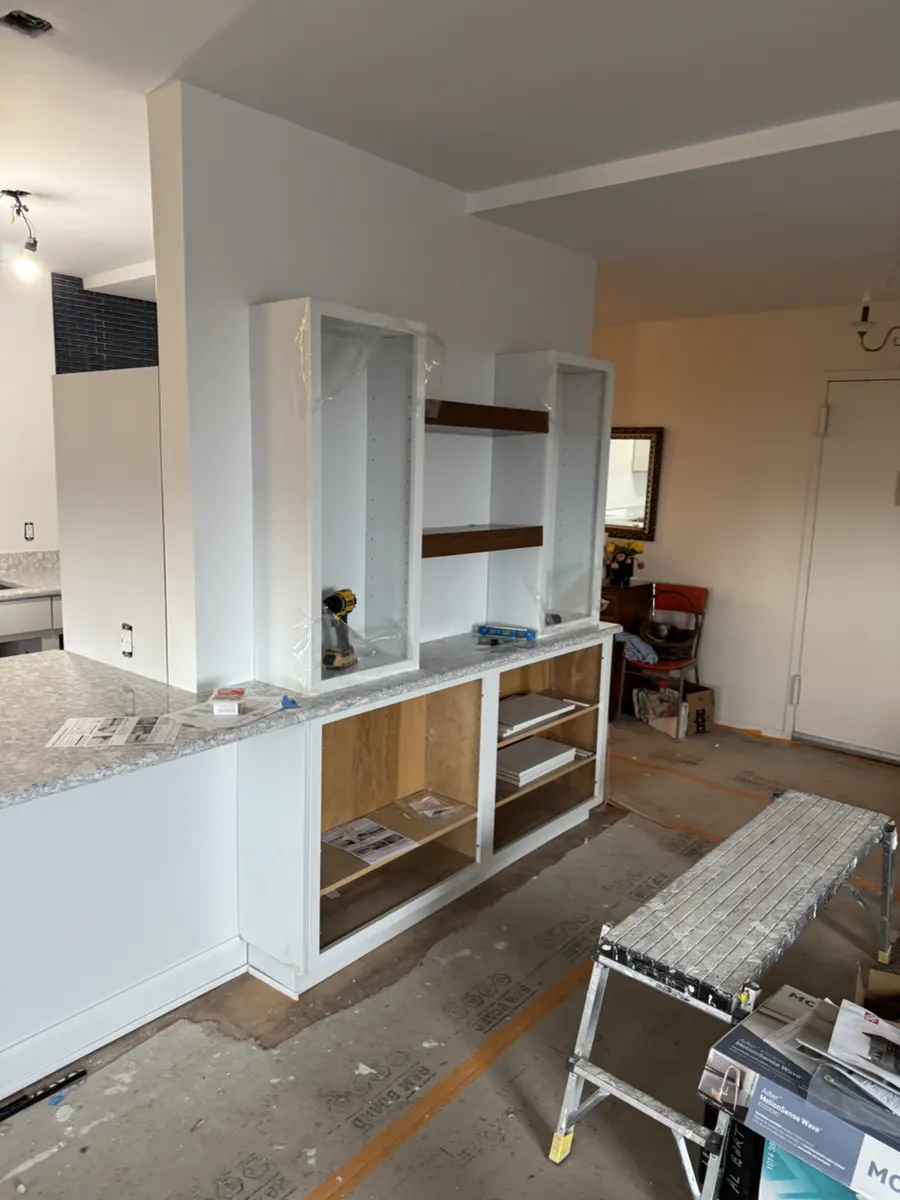 New kitchen opening and storage cabinets taking shape before doors and trim were finished